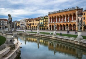 Indian students at University of Padua Italy cycling near Prato della Valle piazza Veneto region