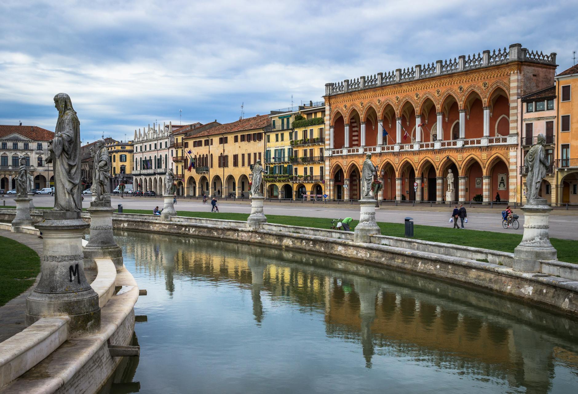 Indian students at University of Padua Italy cycling near Prato della Valle piazza Veneto region